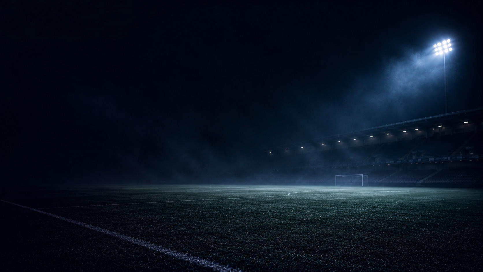 Empty floodlit pitch at night